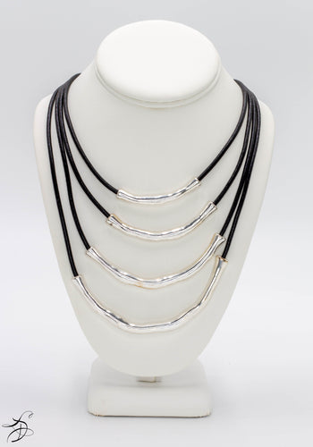 FOUR HAND HAMMERED METAL CYLINDER SHAPED BARS - EACH UNIFIED BY ITS OWN STURDY LEATHER-LIKE BLACK STRING ROPE THAT INTERLOCKS INTO ONE NECKLACE