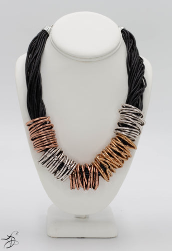 COPPER AND CHROMIUM RING NECKLACE MEDLEY INTERTWINED ON A BUNDLE OF BLACK CHORDS